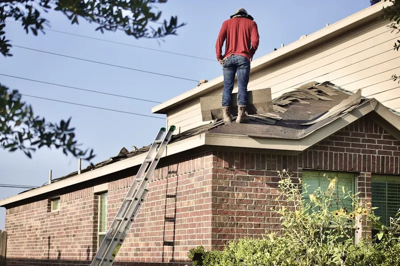 Professional roofer working on a residential roof in Carlyss